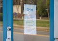 A door sign communicates social distancing guidelines for a business during the novel coronavirus (COVID-19) pandemic.