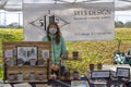 A ceramic designer poses with her work at an outdoor market