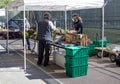 A shopper and vendor wear protective face masks and gloves at the open air Athens Farmers Market