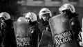 Riot police and protesters during a protest in front of Athens University