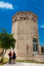 Young couple of tourists visiting the Tower of the Winds or the Horologion of Andronikos Kyrrhestes