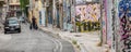 Athens Greece/August 17, 2018: Man in black walking with two black garbage bags walking down the street Royalty Free Stock Photo