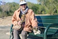 Athens, Greece - Dec 16.2018 An elderly woman and homeless cat