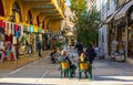 ATHENS, GREECE, DECEMBER 10, 2015: View of a narrow shopping street in the historical district of athens called plaka