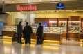 1-8-2018 Athens Greece - Greek orthodox priests chat with a traveler at a bakery at the airport