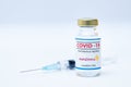 Bottle of coronavirus vaccine with the Astra Zeneca logo and syringe background. Royalty Free Stock Photo
