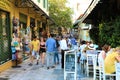 ATHENS, GREECE - JULY 18, 2018: cozy greek street with tourists in cafe e restaurante, Athens, Greece