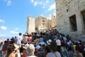 ATHENS, GREECE - JULY 18, 2018: crowd of tourists climbing on the Acropolis between Propylaea monumental gateway, Athens, Greece