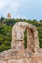 Acropolis stone arch with the view on famous Monument of Philopappos on the top of the hill in Athens, Greece Royalty Free Stock Photo