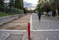 Athens / Greece Man running in Dionysiou Areopagitou street and fireplug in foreground. Active male exercising on stone road Royalty Free Stock Photo