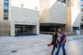 Young greek couple walking in front of modern building of National Bank of