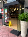 Safety tape on the floor to help customers respect the minimum distance while queuing at a coffee shop in Athens.