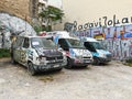 ATHENS, GREECE - MAY 15, 2022: Abandoned minibuses are painted with graffiti on Agiou Konstantinou street