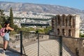 Athens, Greece-Sep 1, 2021: Young lady is admiring the view to the Odeon of Herodes Atticus or Herodion, the Acropolis Museum