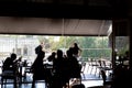 ATHENS, GREECE - SEPTEMBER 17, 2018: Young handsome bartender using smartphone in front of the bar