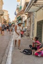 ATHENS, GREECE - SEPTEMBER 16, 2018: Young poor girl playing an accordion in Athens streets