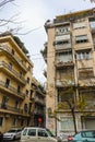 1-04-2018 Athens Greece - Steet scene with multi-floor apartments with balconies loaded with plants and various security covers Royalty Free Stock Photo
