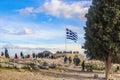 2018_01_03 Athens Greece - Tourists to the Acropolis in Athens gather around the Greek flag taking pictures with The Chapel of St Royalty Free Stock Photo