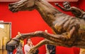 2-04-2018 Athens Greece - Woman contemplates metal statue of the jockey - closeup of grunge broken leg of horse and beautiful head