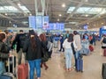 Photo of people checking for their upcoming flights inside the Athens International Airport in Athens, Greece.