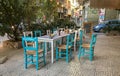 Athens street scene: Blue and white chairs and tables outside an Royalty Free Stock Photo