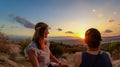 Athens - Young couple  watching sunset over city of Athens seen from Filopappou Hill (hill of muses), Athens, Greece Royalty Free Stock Photo