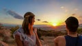 Athens - Young couple  watching sunset over city of Athens seen from Filopappou Hill (hill of muses), Athens, Greece Royalty Free Stock Photo