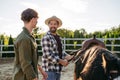 ather and son preparing horse for riding. Royalty Free Stock Photo