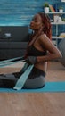 Athetic black woman in sportswear watching aerobic online sport workout Royalty Free Stock Photo
