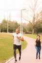 Athetic couple running on footpath in the park Royalty Free Stock Photo