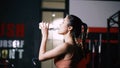 Athlete Asian Woman Drinking Pure Water After Workout Exercise or Training Building Muscles Royalty Free Stock Photo