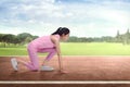 Athlete asian woman runner in ready position ready to run