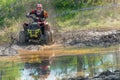 Athlete on the ATV is reflected in the water Royalty Free Stock Photo