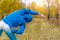 An athlete in an autumn park does fitness exercises.