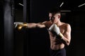 Athlete bag boxer practices The blows the glove black young male boxing, from muscular fighter for combat from caucasian