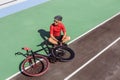 Athlete with a black bicycle at velodrome