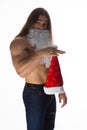 Athlete bodybuilder shirtless with long hair posing in cap Santa Claus Royalty Free Stock Photo