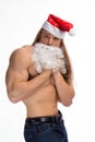 Athlete bodybuilder shirtless with long hair posing in cap Santa Claus Royalty Free Stock Photo