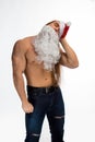 Athlete bodybuilder shirtless with long hair posing in cap Santa Claus Royalty Free Stock Photo
