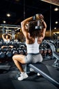 Athlete building her arm muscles at the gym