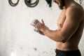 Athlete clapping hands with talc before deadlift barbells workout Royalty Free Stock Photo