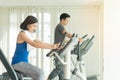 Athlete couples, sport exercise concept. woman and handsome man training on machine in gym. People workout together on Royalty Free Stock Photo