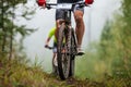 athlete cyclist on mountain bike riding uphill in forest front view Royalty Free Stock Photo