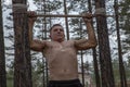 The athlete does push-ups on a makeshift bar