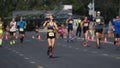 Athlete drink water bottle. Thirsty person run. Woman runner jog sport marathon.