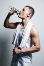 Athlete drinking water. Fitness Boy with bottle. Sport body muscular Man Royalty Free Stock Photo