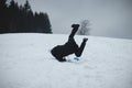 Athlete falls from a plastic snowboard and falls hard on the snow and sprawls. The boy`s board got stuck and it threw him out and