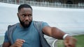 Athlete fighting with shadow on track. Sportsperson warming arms before workout Royalty Free Stock Photo