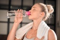 Athlete, fitness and woman drinking water in gym after workout, training or exercise. Sports, nutrition and thirsty Royalty Free Stock Photo