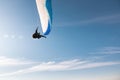 athlete flies on a paraglider. Beautiful paraglider in flight on a blue sky with white clouds on a sunny day Royalty Free Stock Photo